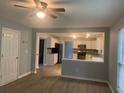 Open living room with neutral walls and vinyl wood flooring at 3730 Oak Park Dr, Suwanee, GA 30024