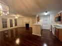 Open kitchen with wood cabinets, white appliances, and a breakfast bar at 713 Cypress Pointe St, Alpharetta, GA 30022