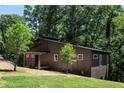 Modern home's side view, showcasing dark siding and a wood-accented porch at 977 Fleetwood Cir, Atlanta, GA 30311