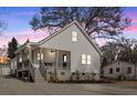 Charming craftsman style home with a covered porch and large backyard at dusk at 1097 Dell Se Ave, Smyrna, GA 30080