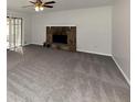 Spacious living room featuring a stone fireplace and neutral carpeting at 1450 Tudor Pl, Grayson, GA 30017