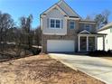 Two-story home with a large driveway and attached garage at 566 Abbott Se Ct, Atlanta, GA 30354