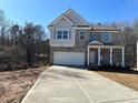 Two-story home with a large driveway and attached garage at 566 Abbott Se Ct, Atlanta, GA 30354