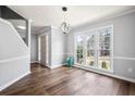 Sunlit living room showcasing wood floors, neutral paint, and decorative lighting at 125 Cinnamon Fern Cir, Covington, GA 30016