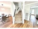 Carpeted staircase in a light-filled entryway at 125 Cinnamon Fern Cir, Covington, GA 30016