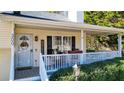 Inviting front porch with rocking chairs and white railings at 300 Orchard Dr, Temple, GA 30179