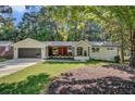 Newly renovated midcentury ranch house with gray garage door at 350 Jayne Ellen Way, Alpharetta, GA 30009