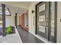 Modern front entry with dark gray door and wood accent wall at 350 Jayne Ellen Way, Alpharetta, GA 30009