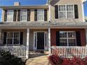 Two-story house with a covered porch and red brick accents at 1563 Nicole Ridge Ct, Loganville, GA 30052