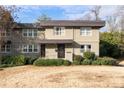 Two-story tan house with dark brown trim, front door, and walkway at 4060 Haverhill Ne Dr # F, Atlanta, GA 30342