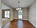 Formal dining room with hardwood floors and a chandelier at 532 Greg Sw Dr, Lilburn, GA 30047