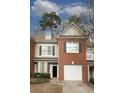 Brick townhouse with attached garage and landscaping at 2353 Maplewood Se Ct # 25, Atlanta, GA 30339