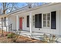 Inviting front porch with red door and black shutters at 3781 Hickory Ridge Ct, Marietta, GA 30066