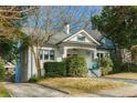 White brick home with a red door and driveway, surrounded by trees at 648 Cooledge Ne Ave, Atlanta, GA 30306