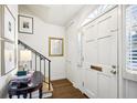 Bright entryway with hardwood floors, stairs, and a small table at 15 Independence Nw Pl, Atlanta, GA 30318