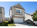 Two-story home with neutral siding, brick accents, and a two-car garage at 150 Auburn Depot Dr, Auburn, GA 30011