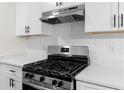 Stainless steel gas range with white cabinets and quartz countertops at 2966 Knollberry Ln, Decatur, GA 30034