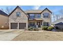 Two-story brick home with a two-car garage and landscaped yard at 527 Mossycup Dr, Fairburn, GA 30213