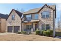 Two-story brick home with a two-car garage and landscaped yard at 527 Mossycup Dr, Fairburn, GA 30213