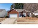 Red brick ranch house with a two-car garage and manicured lawn at 175 Robin Ct, Fayetteville, GA 30215