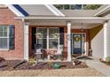 Front porch with rocking chairs, flower baskets, and landscaping at 4334 Austin Farm Trl, Acworth, GA 30101