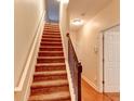 Carpeted staircase with a dark wood railing at 6033 Bayrose Cir # 33A, East Point, GA 30344
