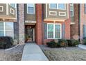 Brick townhouse exterior with a walkway and landscaping at 6033 Bayrose Cir # 33A, East Point, GA 30344