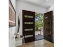 Light and airy entryway with dark wood door and unique decor at 697 Kendall Ne St, Atlanta, GA 30312