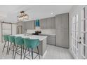 Stylish kitchen with gray cabinets, a quartz countertop island with seating, and stainless steel appliances at 218 Forkner Dr # D, Decatur, GA 30030