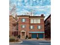 Attractive brick exterior with blue accents, a portico over the front door, and a two-car garage at 5890 Bond St, Cumming, GA 30040