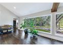 Living area featuring hardwood floors, large windows, and a lush potted plant at 9585 Hutcheson Ferry Rd, Palmetto, GA 30268