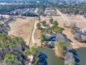 Aerial view of property showcasing home, pond, and trees at 3228 Rosebud Rd, Loganville, GA 30052