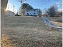 House on a hill with a long driveway and snowy yard at 1485 Reynolds Sw Rd, Atlanta, GA 30331