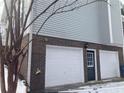 Two-car garage with brick facade and white doors at 1485 Reynolds Sw Rd, Atlanta, GA 30331