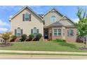 Two-story house with beige siding, brick accents, and a well-manicured lawn at 45 Silver Peak Dr, Covington, GA 30016