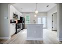 Modern kitchen with white cabinets, stainless steel appliances, and an island at 59 Stafford Nw St, Atlanta, GA 30314