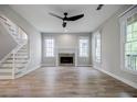 Spacious living room featuring hardwood floors, fireplace, and large windows at 59 Stafford Nw St, Atlanta, GA 30314