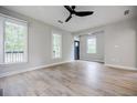 Bright living room features wood-look floors, a modern ceiling fan and large windows at 59 Stafford Nw St, Atlanta, GA 30314