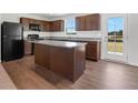 Kitchen island with granite countertops and dark brown cabinets at , Stone Mountain, GA 30087