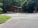 Asphalt driveway leading to a log cabin home in the woods at 218 Helen Rd, Covington, GA 30016