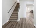 Staircase and wood-look flooring in the entryway at 5547 Strathmoor Manor Cir, Lithonia, GA 30058