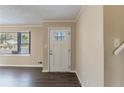 Front entry with white door and dark laminate floors at 2473 Tyler Way, Decatur, GA 30032