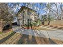 Two-story house showcasing a side view, with a curved driveway and landscaping at 1159 Morley Se Ave, Atlanta, GA 30312