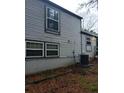 Side view of the house showcasing gray siding and new AC unit at 3195 Newcastle Way, Snellville, GA 30039