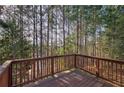 Wooden deck overlooking a wooded area with a view of the trees at 113 Omega Ct, Dallas, GA 30157