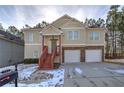 Tan two-story house with two car garage and red stairs at 113 Omega Ct, Dallas, GA 30157