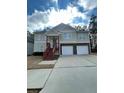 Two-story house with a two-car garage and a red wooden staircase at 113 Omega Ct, Dallas, GA 30157