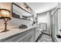 Updated bathroom with white cabinets, marble countertop, and a walk-in shower at 1810 Kinridge Rd, Marietta, GA 30062