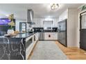 Modern kitchen with white cabinets, large island, and black marble countertops at 1810 Kinridge Rd, Marietta, GA 30062