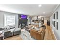 Open living space features hardwood floors, fireplace, and a view into the kitchen at 1810 Kinridge Rd, Marietta, GA 30062